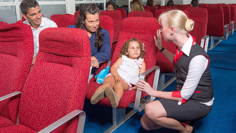 family talking to a staff member on board